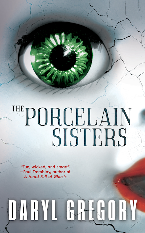 Cover of THE PORCELAIN SISTERS by Daryl Gregory, featuring a partial doll's face, with white porcelain skin with many cracks, focusing on a green glass eye and red lips